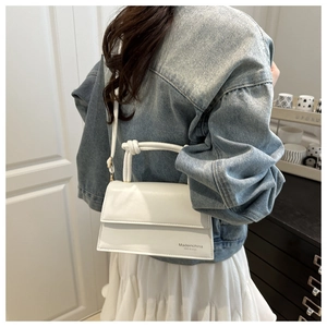 Detailed view of white PU leather crossbody bag featuring a knotted handle and shoulder strap