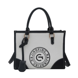 Large capacity canvas tote bag with black and white contrast lettering and top handles