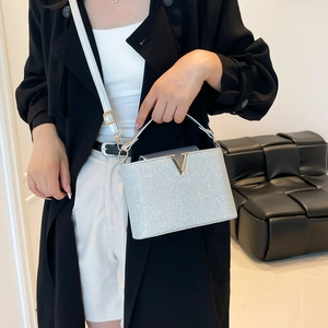 Silver sequin crossbody bag with gold V-metal hardware and a stylish top handle strap