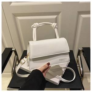 Detailed shot of white PU leather crossbody bag featuring a unique braided rope handle