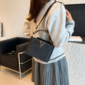 Sparkly black glitter handbag with gold V-hardware and leather strap for women