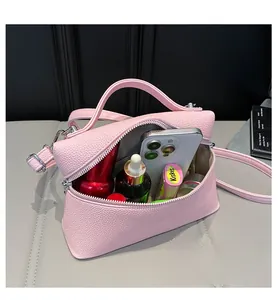 Detail view of pink lychee leather crossbody bag interior showing spacious storage