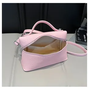 Detailed interior view of pink pebble leather bag showing large capacity and inner pocket