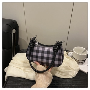 Detail der schwarz-grau karierten Halbmond-Handtasche mit modischem Ledergriff-Design