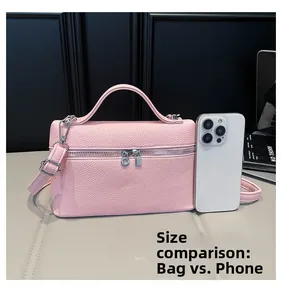 Size comparison between the pink pebble leather crossbody bag and a mobile phone