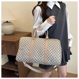 Large capacity travel duffel bag with vintage pattern worn by a model in a home setting