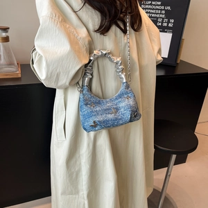 Fashionable blue denim hobo bag with silver butterfly charms and metallic handle