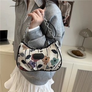 Fashionable floral print crossbody bag with chain strap and leather logo detail