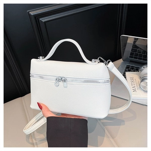 Detailed macro shot of white lychee textured box bag with premium silver hardware and zipper