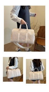 Detail view of large travel bag with brown M monogram print and white leather handles