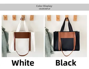 Detail of canvas tote bags in white and black with brown leather patch and slim straps