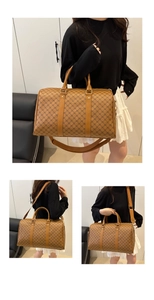 Macro detail of brown travel bag with vintage pattern and polished gold-tone hardware