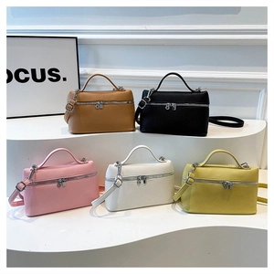 Group display of chic vanity bags in five colors with top handles and shoulder straps