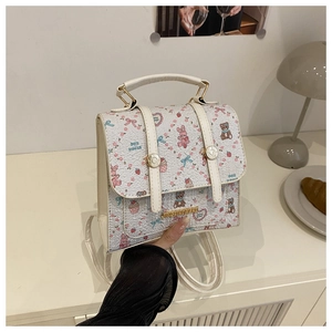 Detail of floral printed mini backpack featuring cartoon patterns and metal buckle