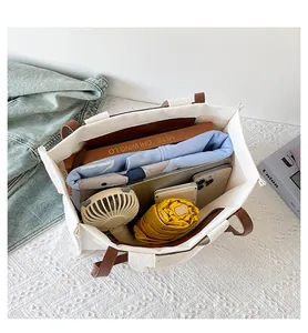 Top view of spacious canvas tote bag interior showing capacity for books and laptop