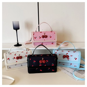 Detail of colorful cherry print mini handbags with 3D cherry charm in four colors