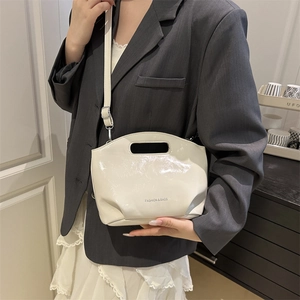 Minimalist beige glossy shell crossbody bag with top handle and letter print for women