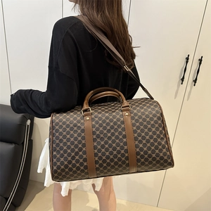 Brown monogram duffel bag with leather handles shown in a modern home interior