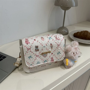 Chic cartoon print square handbag in cream with teddy bear motifs and rabbit charm