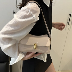 Minimalist beige underarm bag with glossy finish and stylish gold metal lock buckle