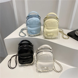 Mini high-gloss leather backpack with lace trim and bow in blue, yellow, black and white