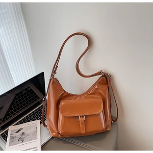 Close-up of caramel PU leather tote showing large capacity and metallic buckle detail