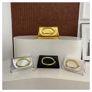 Four colors of faux leather crossbody bags with gold oval buckles and chain straps