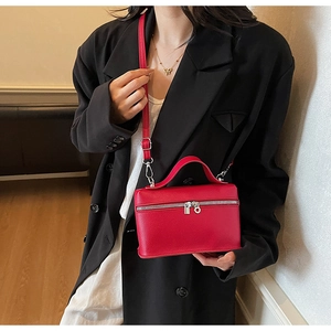 Chic red leather vanity bag with litchi texture and silver hardware shown on model