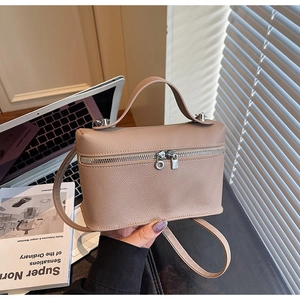 Detail of nude pink box bag with pebble leather texture and silver hardware