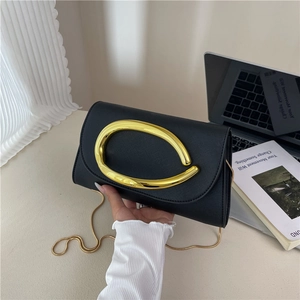 Minimalist black Saffiano leather crossbody bag with oversized golden metal ring detail