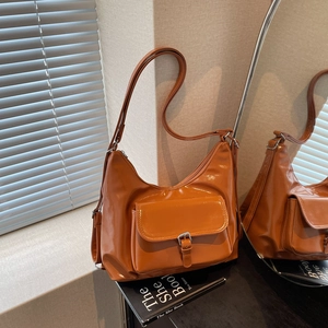Caramel glossy leather hobo shoulder bag with adjustable strap and front pocket
