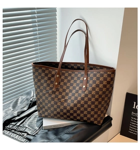 Detail of vintage tote bag with brown checkerboard pattern and slim double shoulder straps