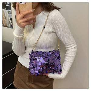 Detailed view of shimmering purple sequin bag with elegant gold metal chain strap