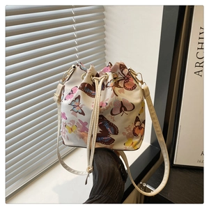 Chic butterfly print drawstring bucket bag with adjustable shoulder strap and gold hardware