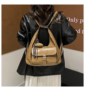 Khaki PU leather tote bag with silk scarf and pom-pom charm shown from a back view