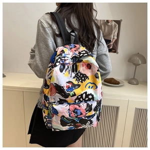 Abstract graffiti nylon backpack featuring colorful prints and adjustable black straps