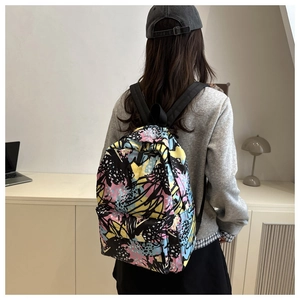 Nylon backpack featuring colorful graffiti print and spacious front zip pocket design
