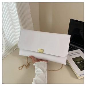 Detailed view of a white envelope bag with golden metallic clasp and elegant chain strap