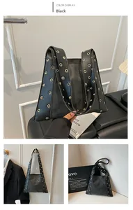 Détail du sac à bandoulière noir avec rivets dorés et large sangle à œillets métalliques