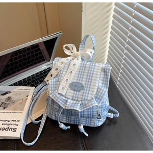 Detailed view of mini checkered backpack with lace bow and drawstring design