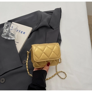 Détail du mini sac bandoulière matelassé doré métallisé avec chaîne dorée et texture de luxe