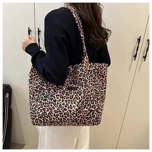 Detail of pink leopard print canvas tote bag with stitched decorative front label