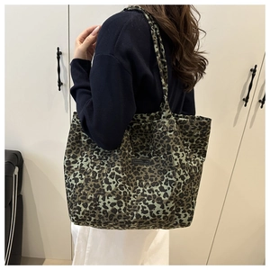 Detail view of leopard print tote bag with durable canvas texture and outer pocket