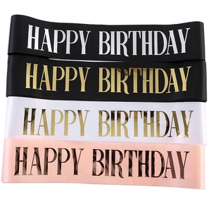 Detail showing four satin Happy Birthday sashes in black, white, and pink with gold foil