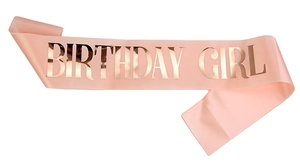 Close-up of pink satin birthday girl sash with rose gold metallic foil lettering