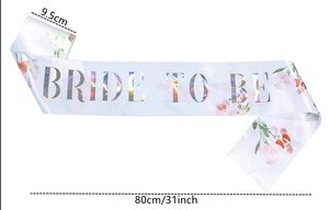 Detail view of white satin Bride To Be sash with floral print and 9.5x80cm dimensions