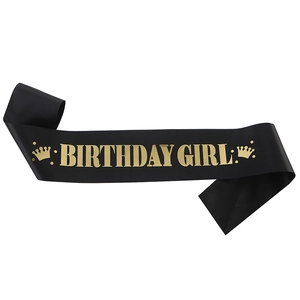 Elegant black satin Birthday Girl sash with metallic gold lettering and crown icons