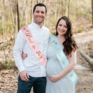 White satin Mom to Be and Dad to Be sash set with gold glitter lettering for baby shower