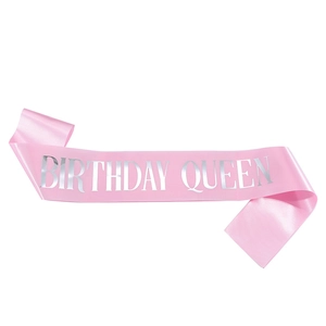 Close-up of pink satin birthday queen sash with shiny silver lettering for party events