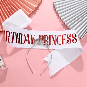 Detail of Birthday Princess glitter sash and rhinestone tiara on a pink aesthetic background